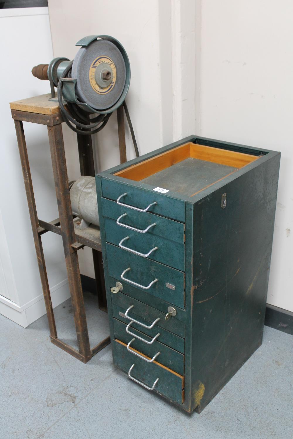 An industrial metal eight drawer chest together with an electric grinder on metal stand