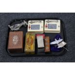 A tray containing two practice morse code tappers, a Golden Flake tin containing dominoes,