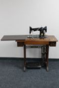 A mid 20th century Singer treadle sewing machine in table