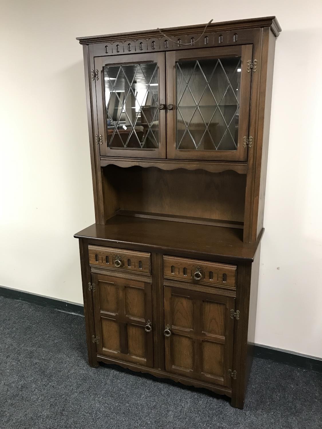 An oak leaded glass door dresser