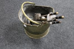 An early 20th century brass coal bucket together with a companion set