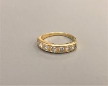 An 18ct gold seven stone brilliant cut diamond ring, approximately 0.