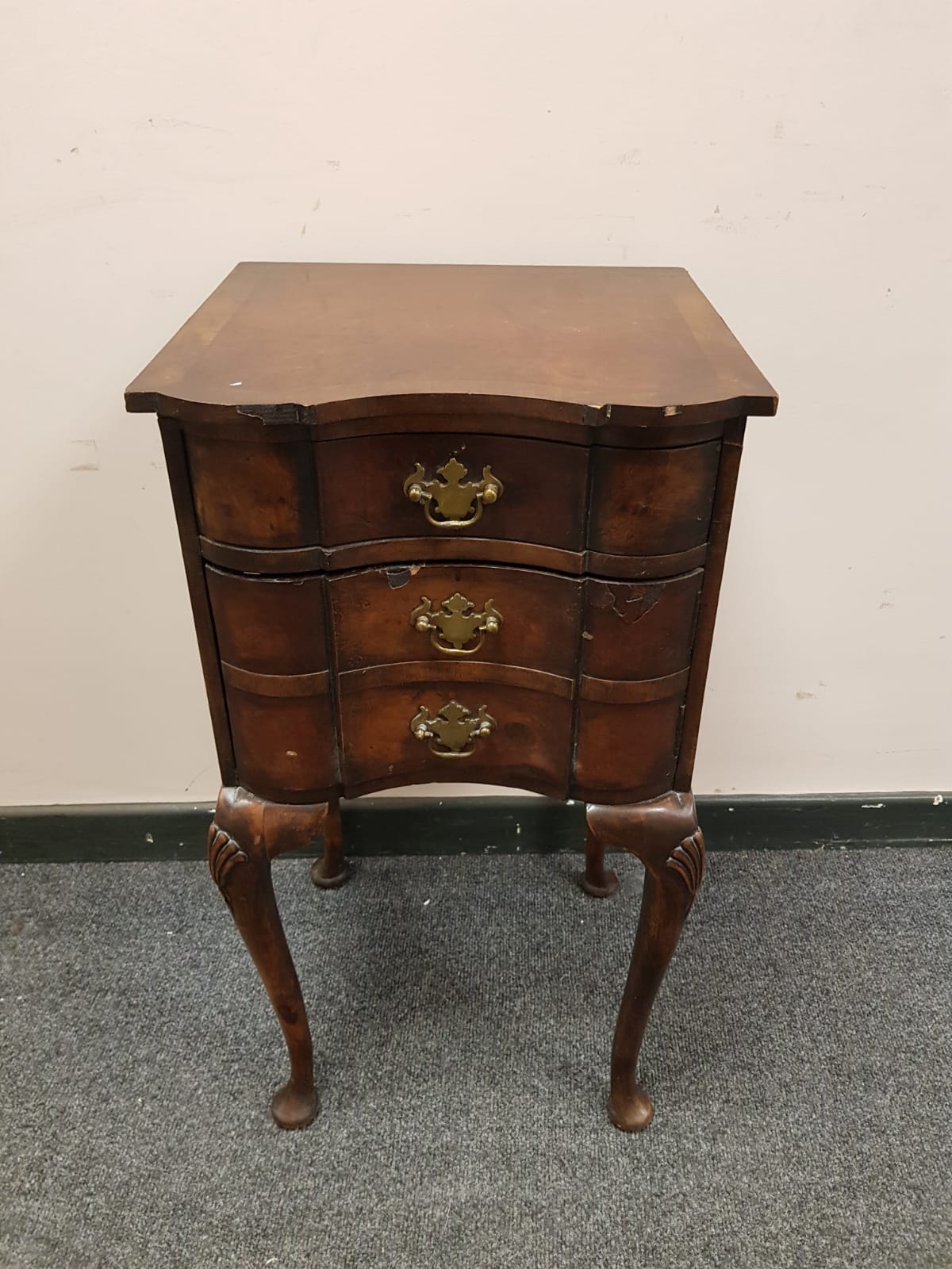 A 19th century walnut three drawer bedside chest on cabriole legs, width 38 cm.