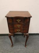 A 19th century walnut three drawer bedside chest on cabriole legs, width 38 cm.