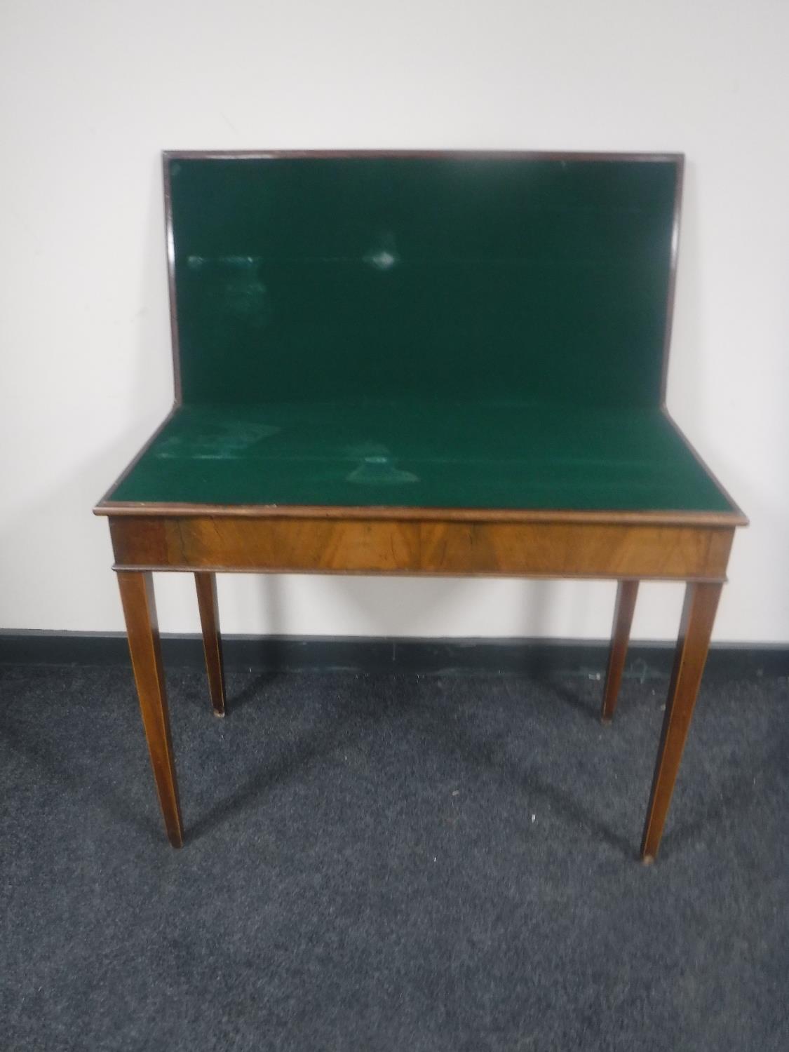 A 19th century mahogany foldover tea table