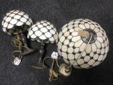 A Tiffany style light fitting and a pair of matching table lamps