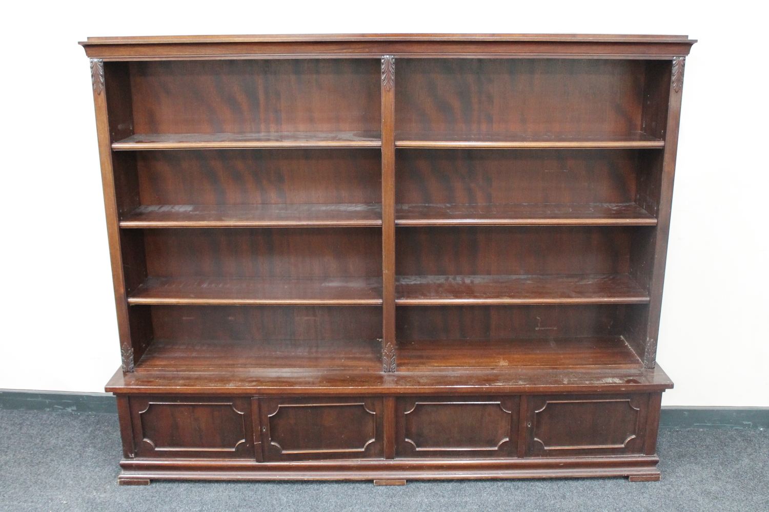 A 20th century mahogany open bookshelves fitted two double door cupboards beneath