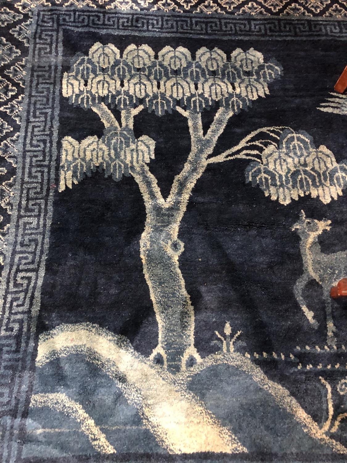 A fringed Chinese rug on blue ground depicting fauna, - Image 8 of 11