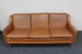 A mid 20th century Danish three seater brown leather settee on chrome legs