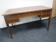 A Victorian inlaid mahogany five drawer writing desk with brown leather inset panel