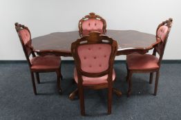 An Italianate pedestal dining table together with four dining chairs upholstered in pink buttoned