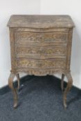 An early twentieth century continental carved oak three drawer chest on cabriole legs (a/f)