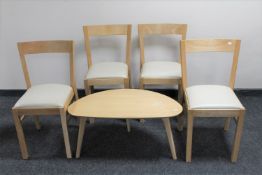 A contemporary pebble coffee table together with a set of four contemporary leather seated dining