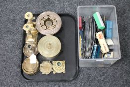 A tray of brass ware and a plastic tub of rolling stock and track