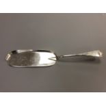An antique silver crumb scoop