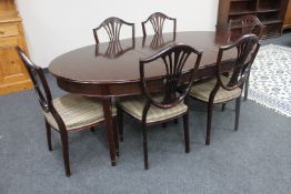 A continental mahogany oval Regency style extending dining table with three leaves and six single