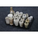 A tray containing approximately twenty-one cream ware bottles and kitchen jars,