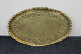 A large oval Indo-Persian brass pie crust edge tray