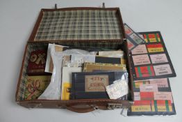 A 20th century suitcase containing a large quantity of first day covers, stamps, luggage labels,