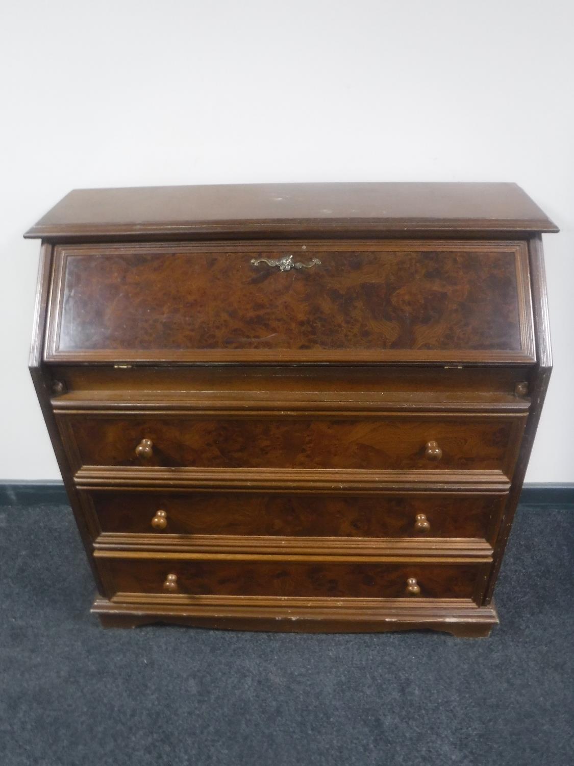 A continental bureau in a walnut finish together with a mahogany double door cabinet fitted a