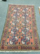 An antique Afghan Bokhara rug on salmon ground,