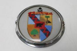 A vintage car badge with marked 64 medium Regt R.