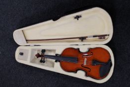 A violin and bow in a fitted carry case