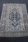 An Eastern rug on cream and blue ground,