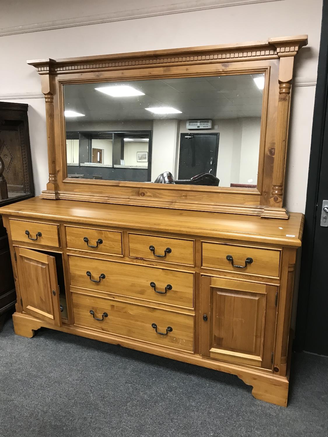 A contemporary pine sideboard (width 180 cm) with mirrored back.