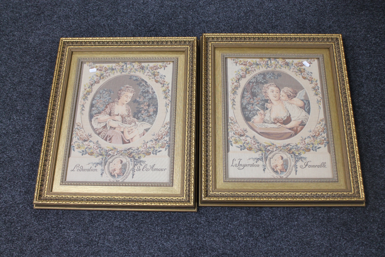 A pair of gilt framed French tapestries depicting a female with cherub