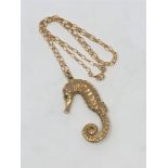 A 9ct gold seahorse pendant with emerald set eyes, on chain CONDITION REPORT: 21.