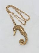 A 9ct gold seahorse pendant with emerald set eyes, on chain CONDITION REPORT: 21.