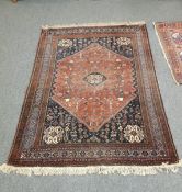 A South-West Iranian Kashgai rug on indigo and terracotta ground 210 cm x 150 cm.