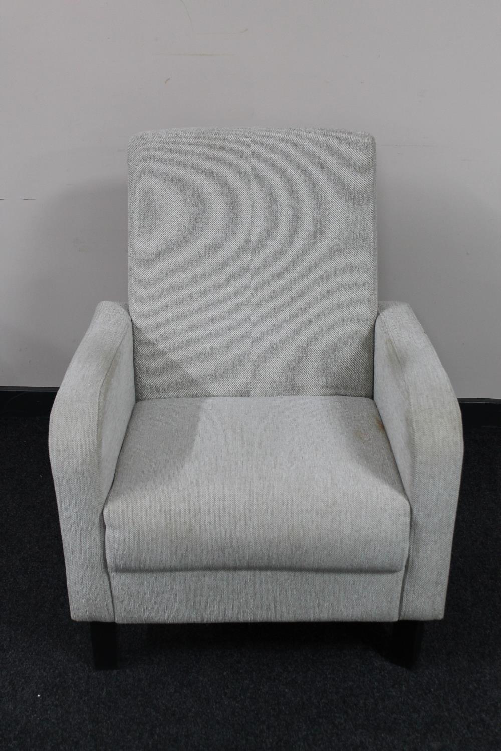 A late 20th century armchair upholstered in a beige fabric