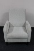 A late 20th century armchair upholstered in a beige fabric
