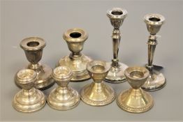 Three pairs of silver candlesticks,