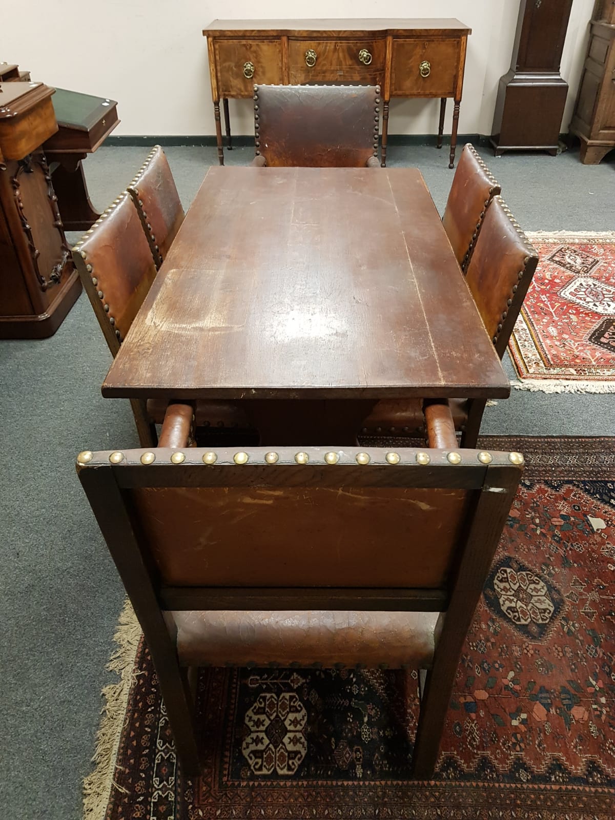 An early 20th century refectory dining table (length 152 cm) together with set of six studded