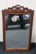 A carved hardwood framed mirror together with an antique oval gilt frame