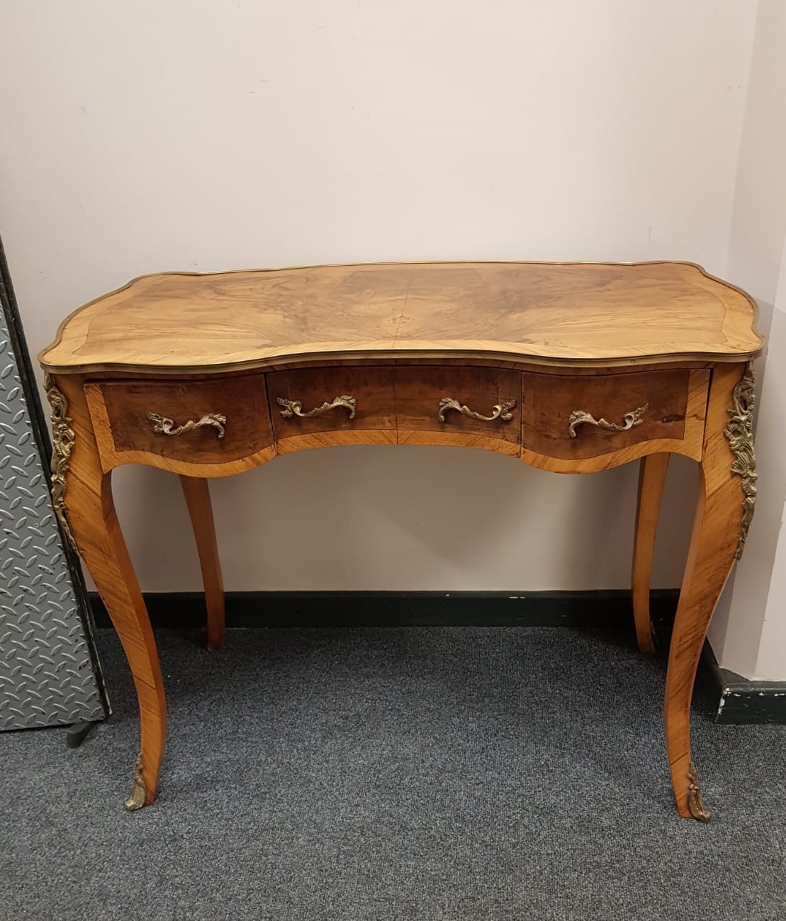 A French figured walnut side table fitted with three drawers,