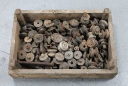 A wooden crate containing a large quantity of antique wooden chest handles