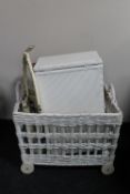 A wicker hamper on wheels together with a cream and gilt dressing table,