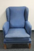 A 20th century wingback armchair upholstered in a blue fabric