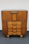A 1930's oak cocktail sideboard fitted four drawers beneath
