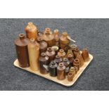 A tray containing approximately twenty-seven antique brown stoneware bottles and jars,