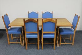 A blond oak refectory dining table together with a set of six dining chairs upholstered in a blue