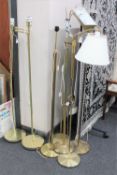 Seven assorted brass floor lamps