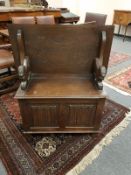 A carved oak early 20th century monk's bench, width 94 cm.