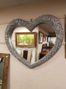 A silvered heart shaped mirror,
