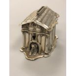 An antique silver dog kennel money box CONDITION REPORT: 9.