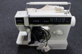 A Singer Samba 6 electric sewing machine with foot pedal and cover